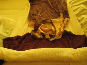 7.  Lay clothing on a towel and roll the towel over them.