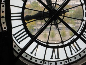 One of the old train station clocks-- with a view of the Seine River