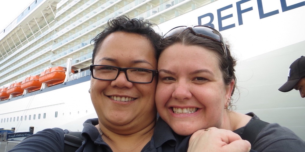 Maylene and Charity smiling in front of the Celebrity Reflection ship on embarkation day