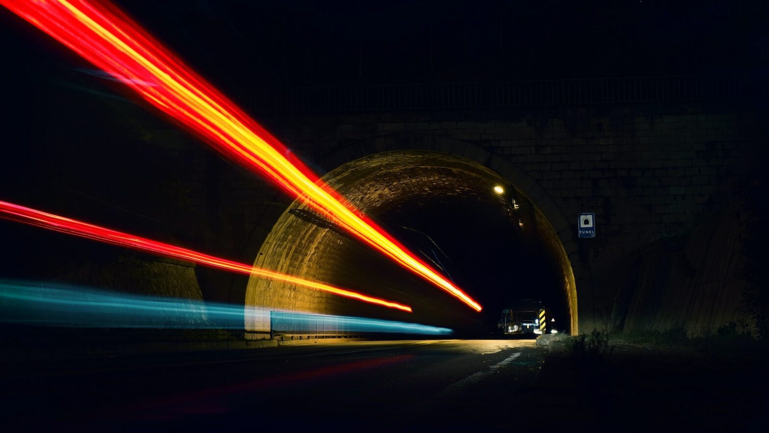 Lights from cars speeding through a tunnel