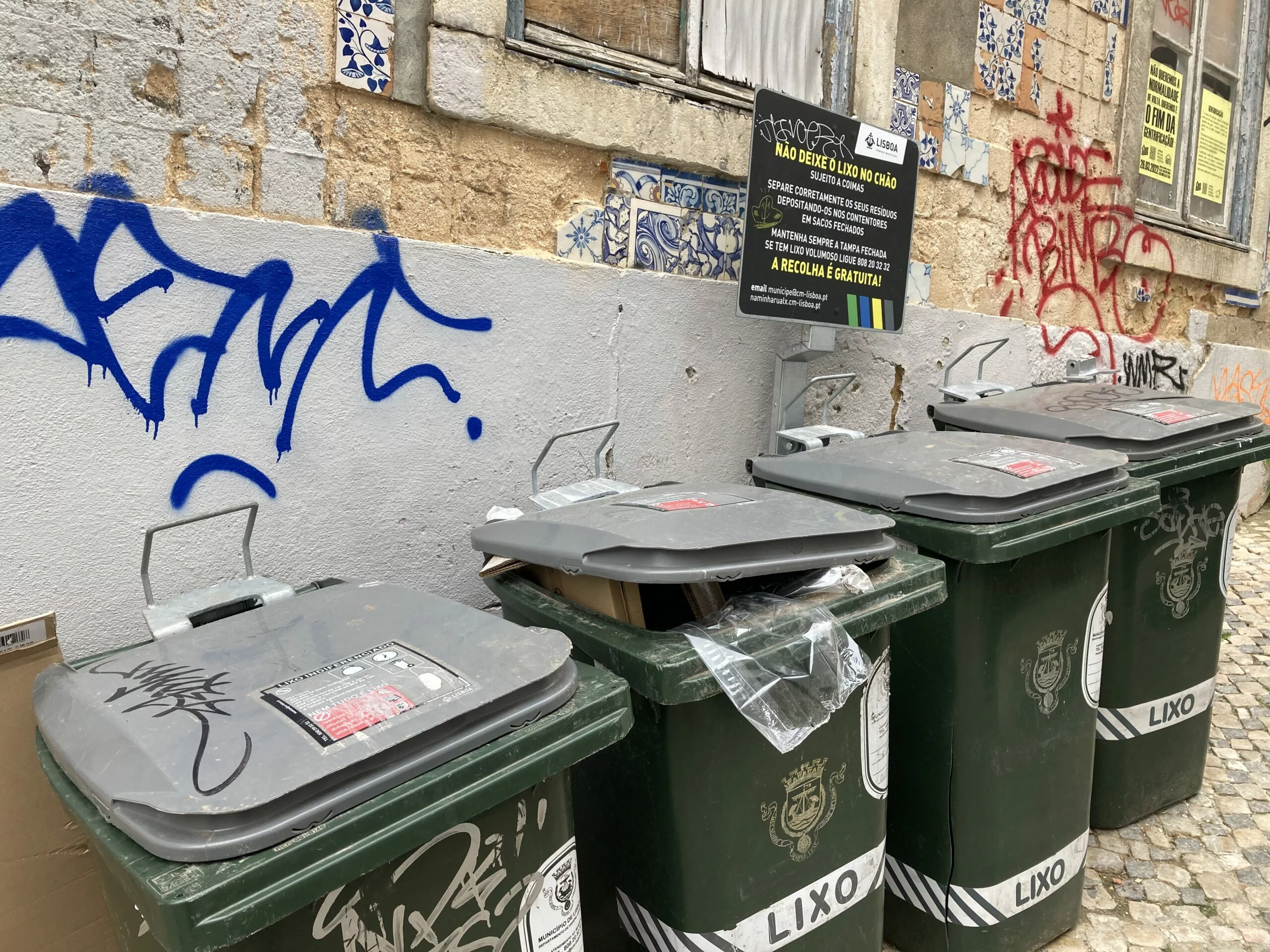 bins of trash located on the streets downtown Lisbon